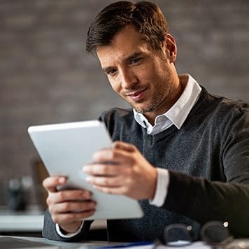 Person reading documents from a tablet