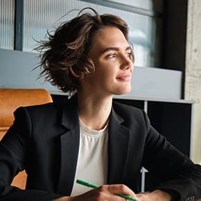 A businesswoman smiling and looking to her right