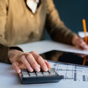 Person using a tablet and calculator