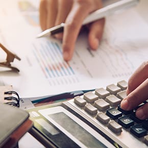 A person calculating and double checking taxes